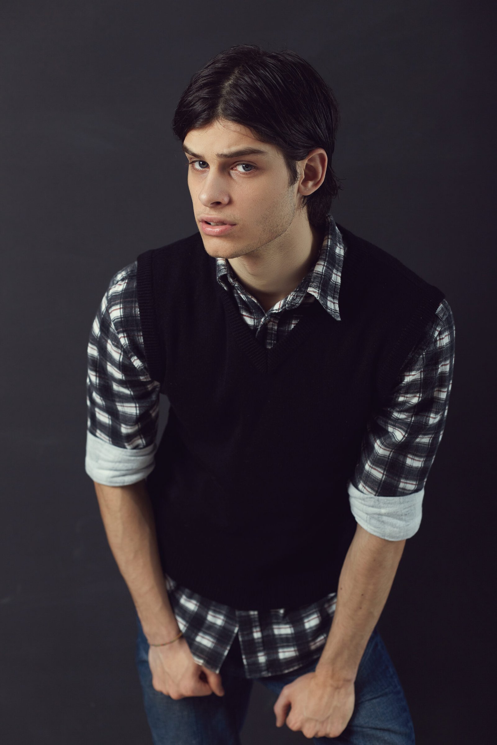 Portrait of an handsome young man posing on a black background